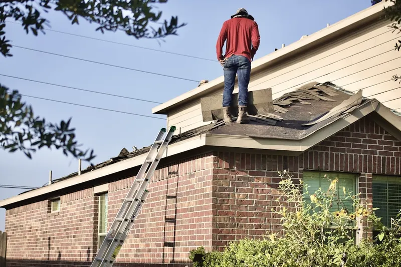Professional roofer working on a residential roof in Penn